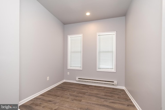 unfurnished room with recessed lighting, a baseboard radiator, baseboards, and wood finished floors