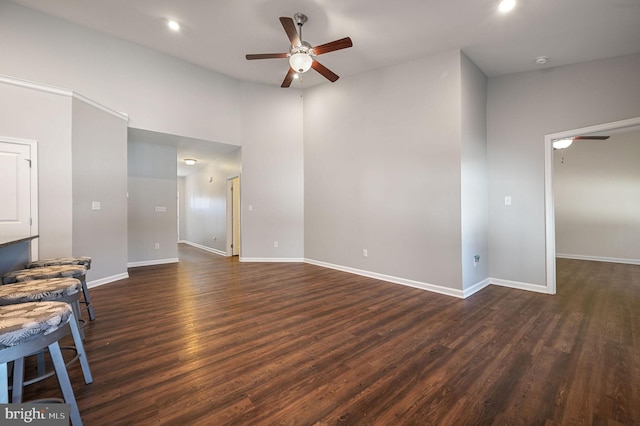 unfurnished living room featuring dark wood-style floors, recessed lighting, a ceiling fan, and baseboards