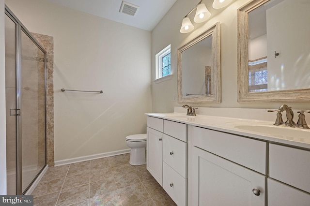 bathroom with visible vents, a shower stall, toilet, and a sink