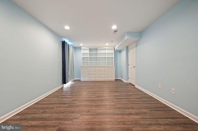 empty room with recessed lighting, visible vents, baseboards, and dark wood finished floors