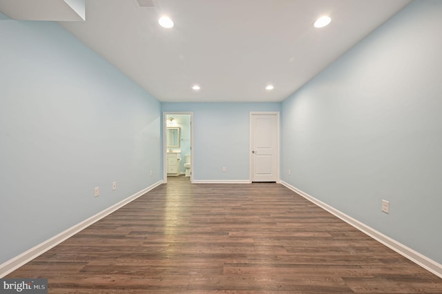 unfurnished bedroom featuring visible vents, baseboards, recessed lighting, dark wood-type flooring, and connected bathroom