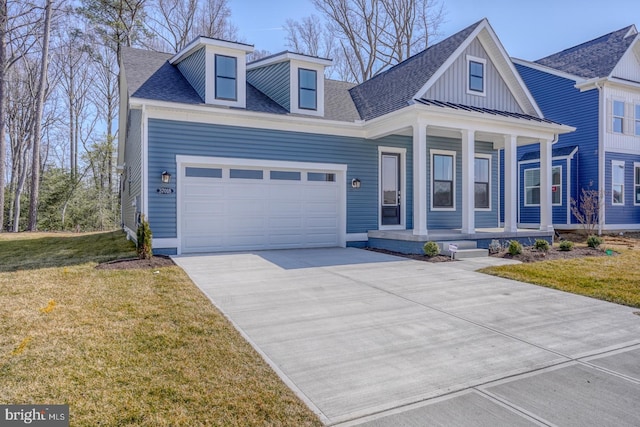 view of front of house featuring driveway, a porch, roof with shingles, a front yard, and an attached garage