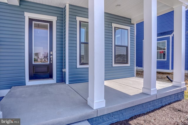 entrance to property featuring a porch