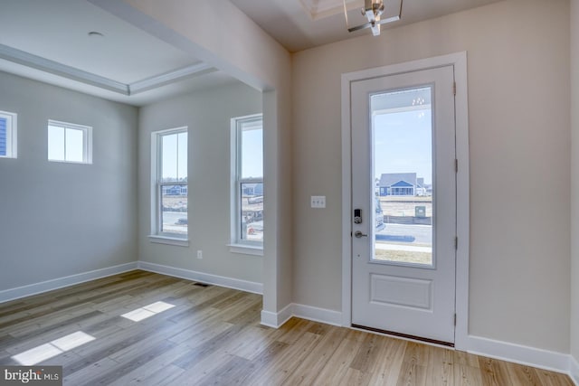 entrance foyer with baseboards and light wood finished floors