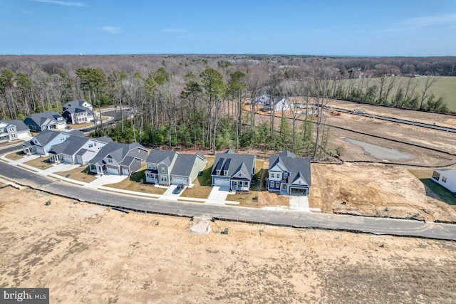 birds eye view of property with a forest view and a residential view