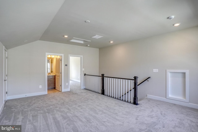 unfurnished room with lofted ceiling, recessed lighting, light colored carpet, and baseboards