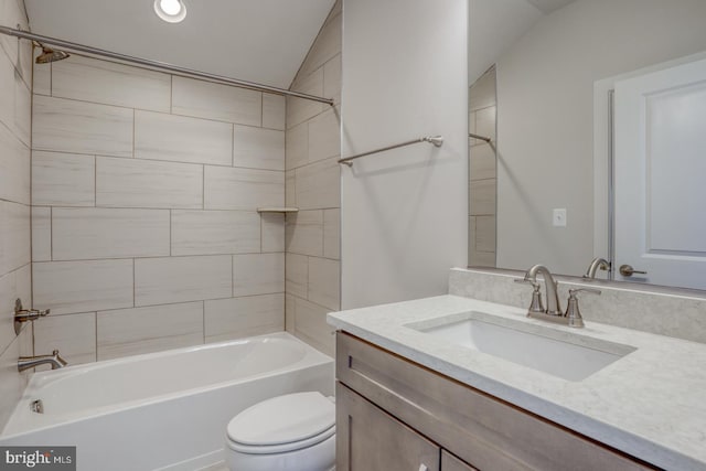 bathroom featuring vanity, shower / tub combination, and toilet