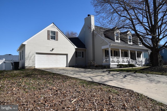 view of side of property featuring a chimney, covered porch, driveway, and an attached garage