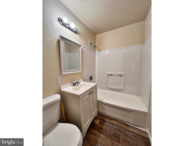 full bath featuring vanity, shower / tub combination, toilet, and wood finished floors