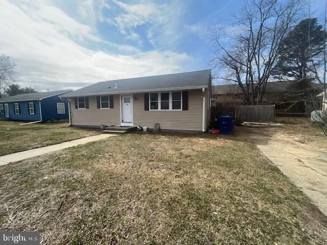 view of front of home with concrete driveway and a front yard