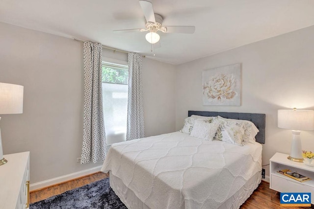 bedroom featuring a ceiling fan, wood finished floors, and baseboards