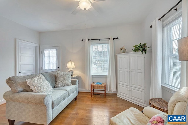 living room with ceiling fan, a healthy amount of sunlight, and wood finished floors