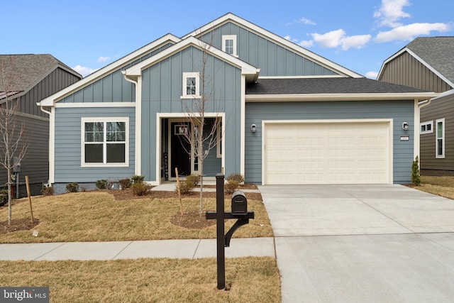 view of front of house featuring a garage, a front yard, board and batten siding, and driveway