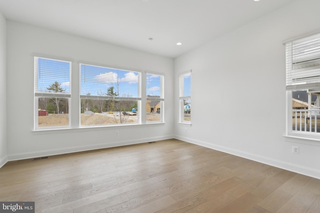 empty room featuring baseboards and wood finished floors