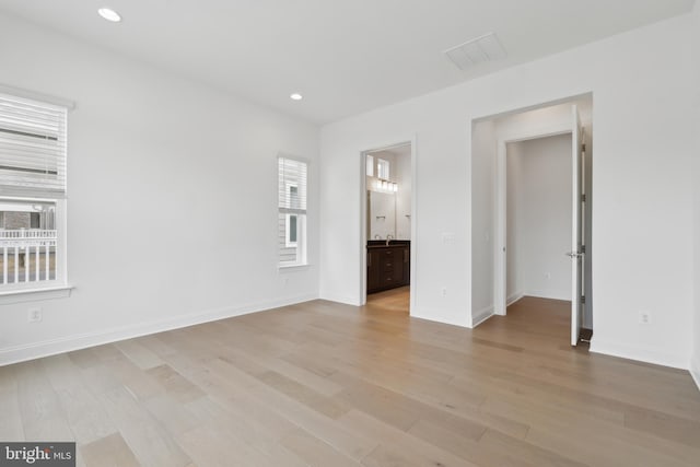 unfurnished bedroom with light wood-style flooring, recessed lighting, visible vents, and baseboards