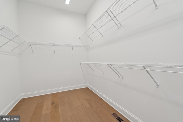 spacious closet featuring light wood-style floors and visible vents