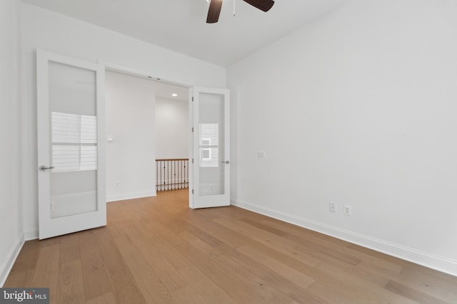 unfurnished bedroom with baseboards, light wood-type flooring, and ceiling fan