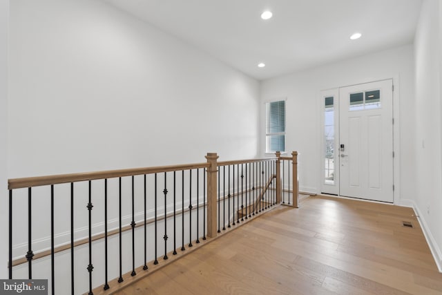 foyer entrance with visible vents, recessed lighting, wood finished floors, and baseboards