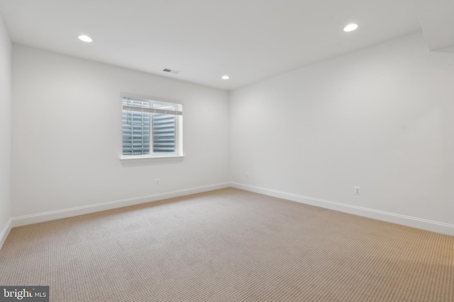 empty room with light carpet, recessed lighting, and baseboards