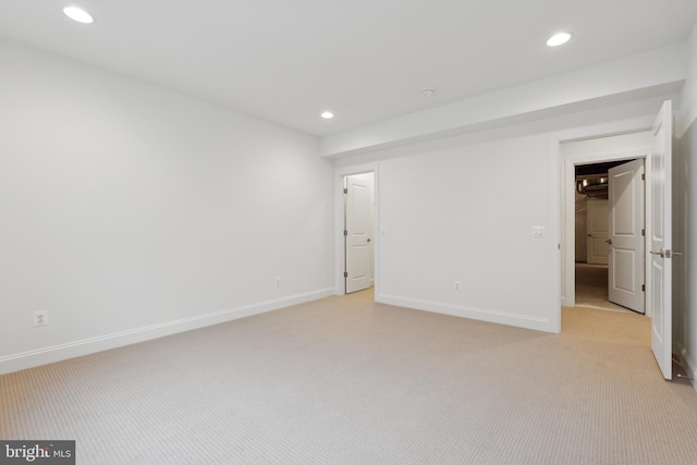 unfurnished bedroom featuring recessed lighting, baseboards, and light carpet