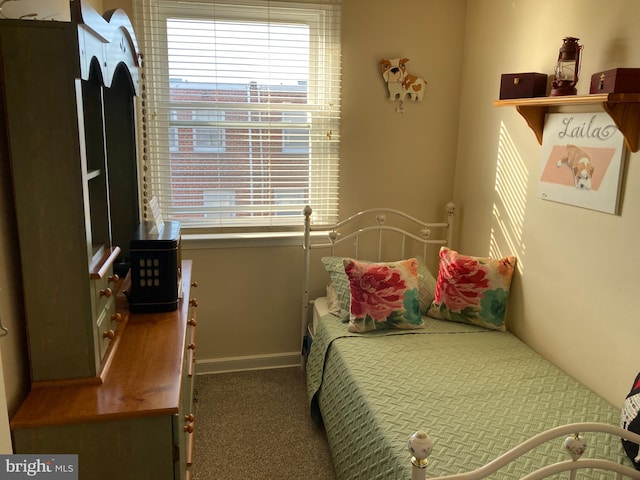 carpeted bedroom featuring baseboards