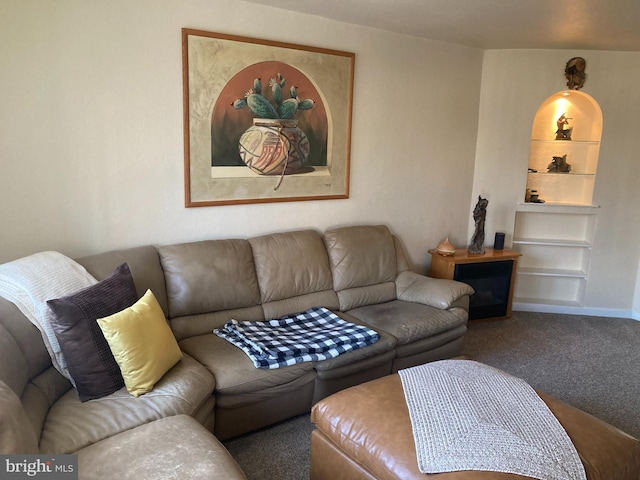 living room with built in features, baseboards, and carpet