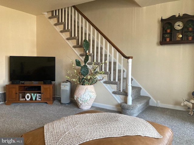 stairs with visible vents, carpet, and baseboards