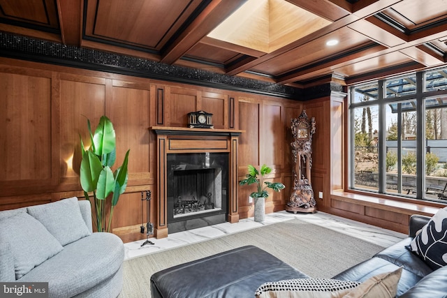 living room with beam ceiling, wooden walls, a fireplace, and coffered ceiling