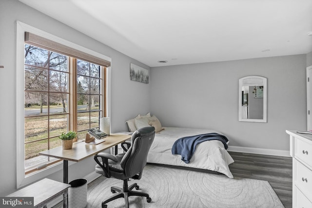 bedroom with dark wood-style floors and baseboards