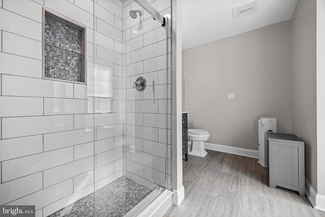 full bath featuring a stall shower, toilet, and baseboards