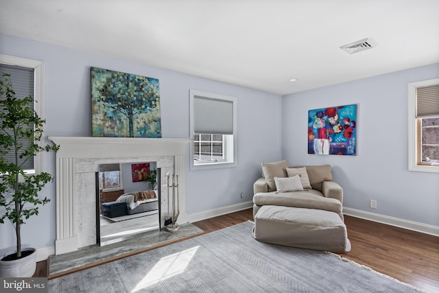 sitting room featuring visible vents, wood finished floors, and baseboards