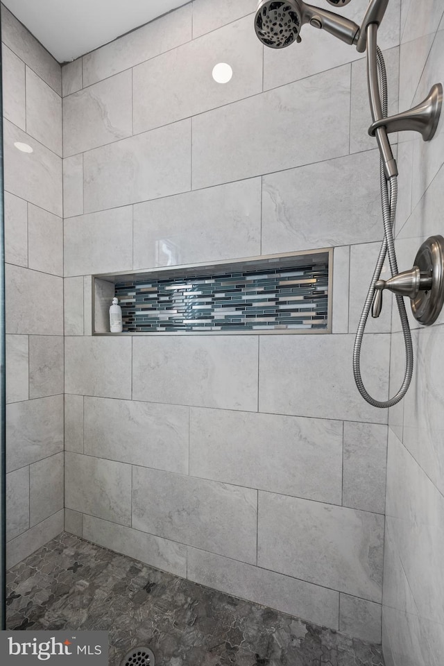 full bathroom with tiled shower