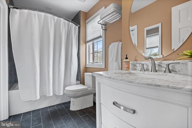 bathroom featuring tile patterned flooring, toilet, vanity, and shower / tub combo with curtain