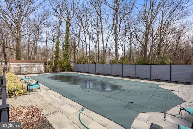 view of swimming pool with a patio area, a fenced in pool, and fence