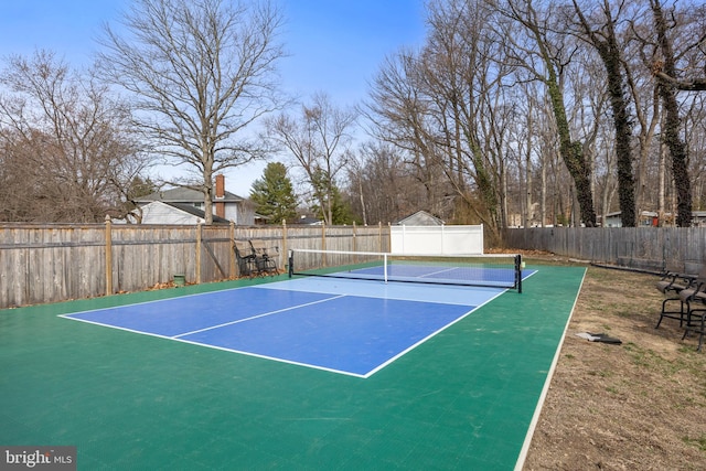 view of tennis court featuring fence