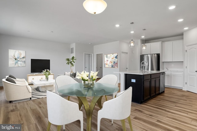 dining room featuring recessed lighting, visible vents, and light wood finished floors