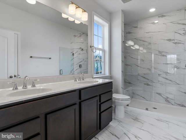 bathroom with toilet, marble finish floor, a marble finish shower, and a sink