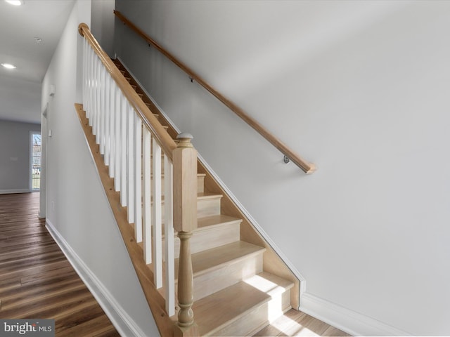 staircase with recessed lighting, baseboards, and wood finished floors