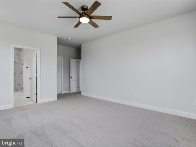 unfurnished bedroom featuring ensuite bath, baseboards, and light carpet