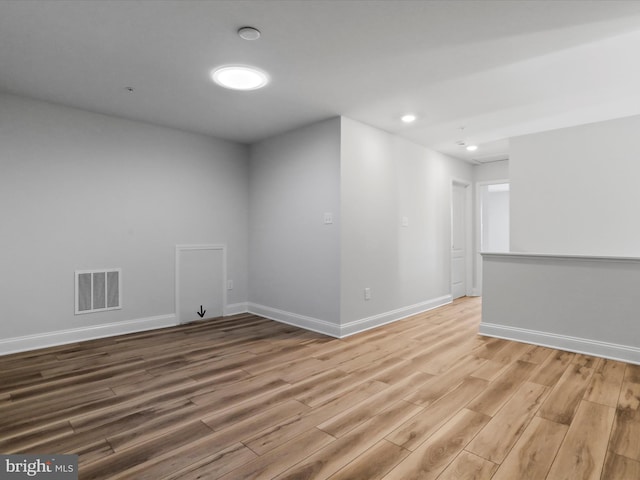 unfurnished room with recessed lighting, baseboards, visible vents, and light wood-type flooring