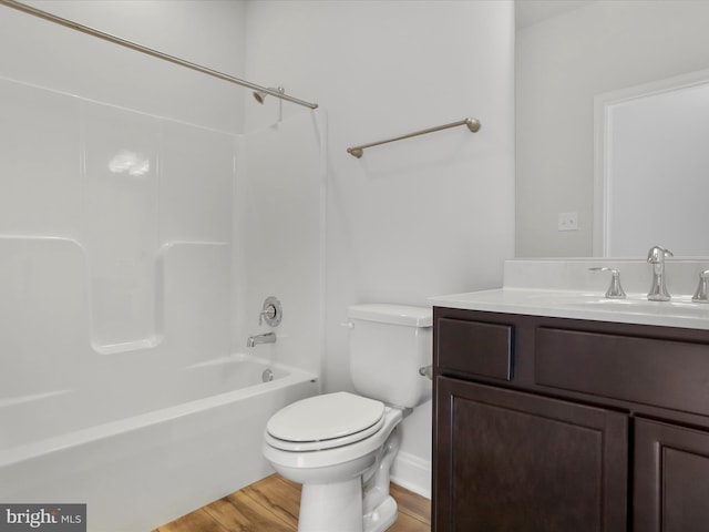 full bath with toilet, shower / washtub combination, wood finished floors, and vanity