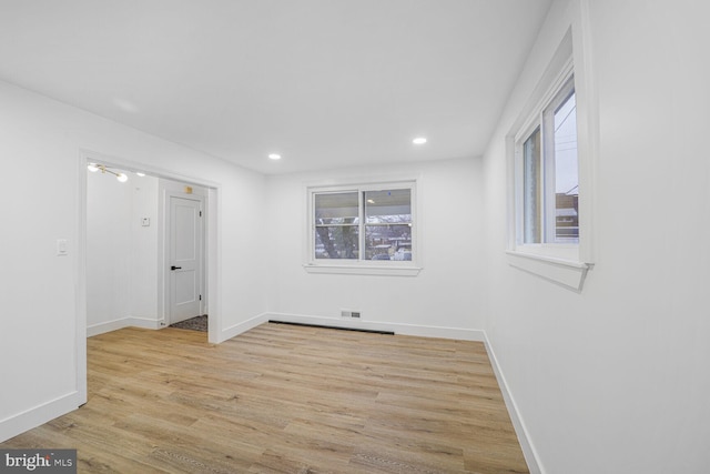 unfurnished room with visible vents, recessed lighting, light wood-type flooring, and baseboards