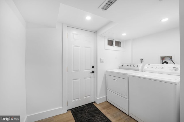 laundry area featuring washing machine and clothes dryer, visible vents, laundry area, recessed lighting, and light wood-style floors