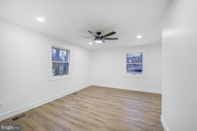 spare room with a ceiling fan, wood finished floors, visible vents, baseboards, and recessed lighting