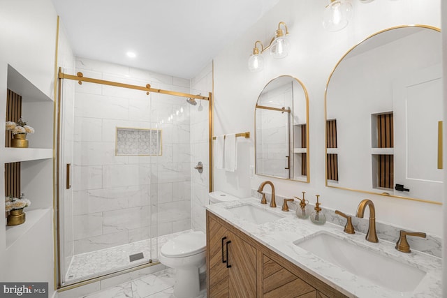 bathroom with marble finish floor, toilet, a shower stall, and a sink