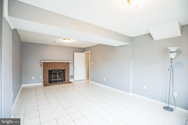 unfurnished living room featuring visible vents, light tile patterned floors, a fireplace, and baseboards