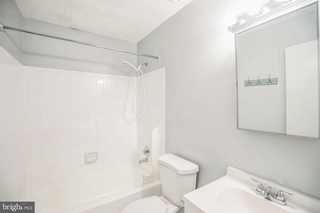 full bath with washtub / shower combination, a textured ceiling, vanity, and toilet