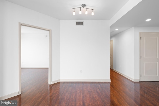 unfurnished room featuring visible vents, recessed lighting, baseboards, and wood finished floors