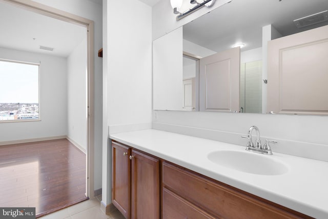 bathroom with visible vents, vanity, and baseboards