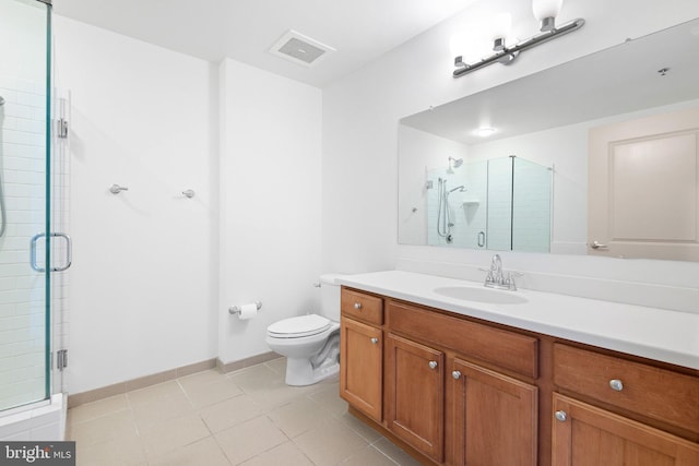 bathroom with toilet, a stall shower, tile patterned flooring, baseboards, and vanity